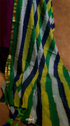 Close-up of a colorful striped fabric with green, yellow, and blue patterns.