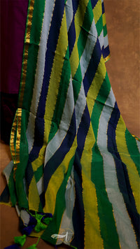 Close-up of a colorful striped fabric with green, yellow, and blue patterns.