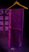 Purple fabric on a wooden hanger against a dark background