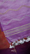 Purple fabric with gold and white stripes and tassels on a red background