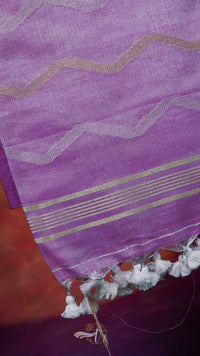 Purple fabric with gold and white stripes and tassels on a red background