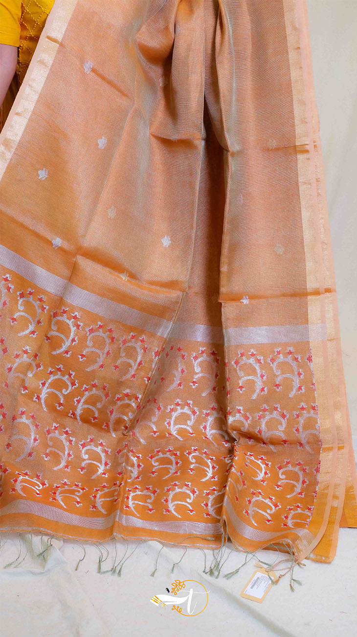 Orange saree with white patterns on a plain background