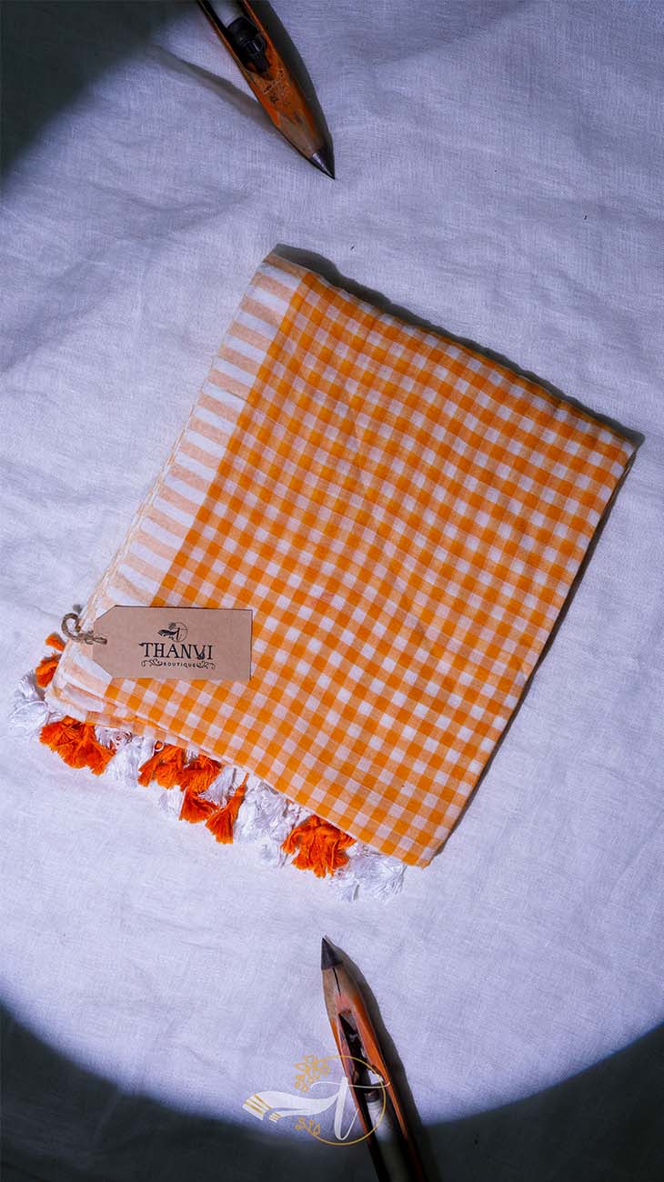 Orange checkered towel with tassels on a white background