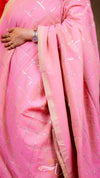 Close-up of a pink saree with a subtle pattern