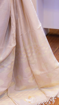 Beige fabric with subtle patterns draped over a chair.