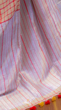 Close-up of a fabric with red and white checkered pattern on a wooden surface.