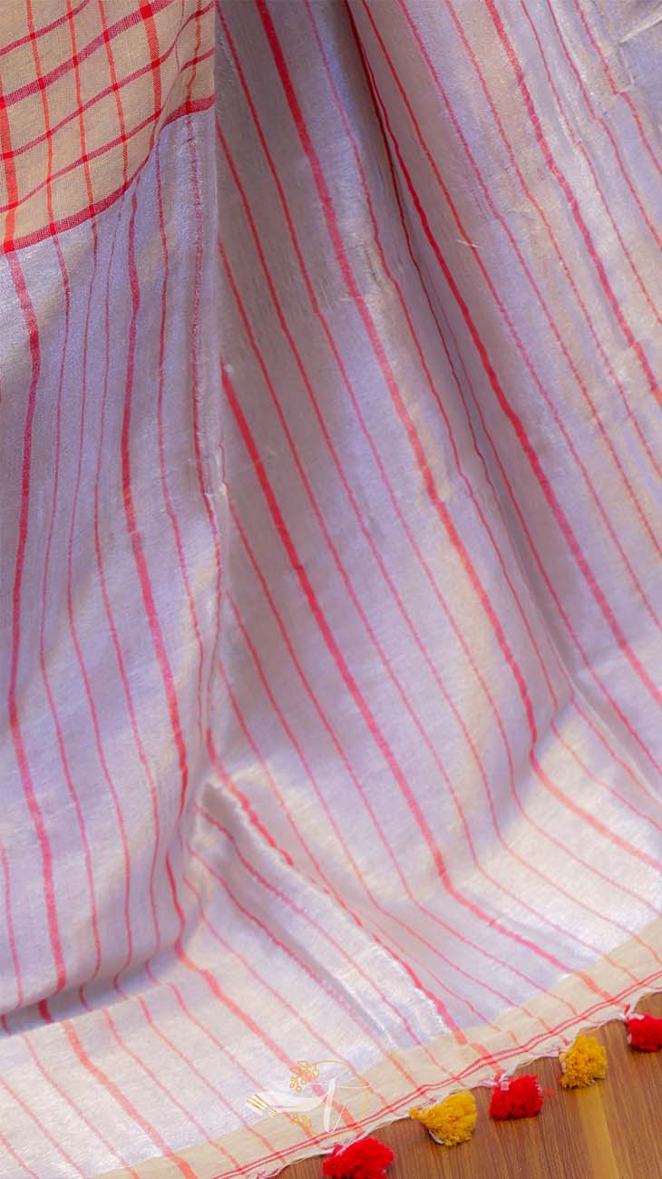 Close-up of a fabric with red and white checkered pattern on a wooden surface.