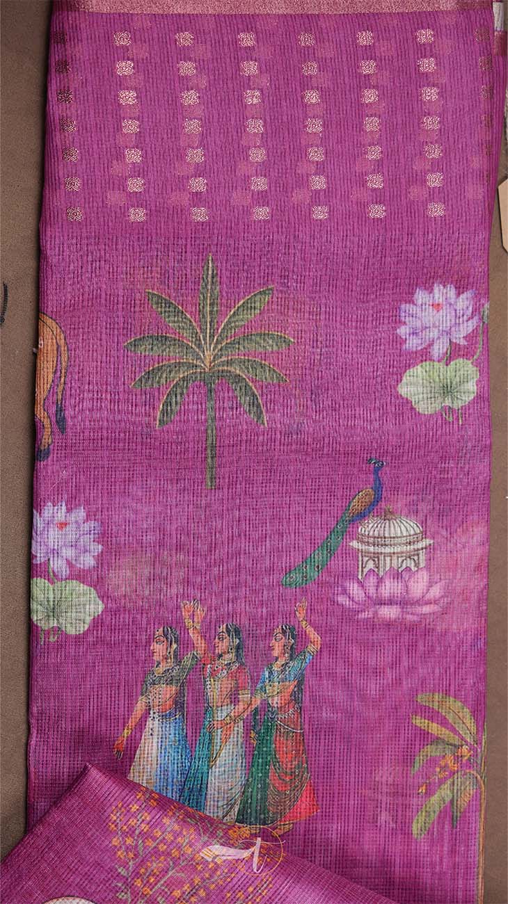 Purple fabric with intricate patterns including palm trees, peacocks, and people in traditional attire.