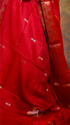 Red fabric with white patterns on a textured background