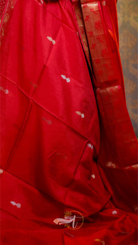 Red fabric with white patterns on a textured background