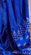 Blue fabric with white patterns, possibly a sari or a similar garment.