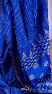 Blue fabric with white patterns, possibly a sari or a similar garment.