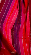 Close-up of red and purple fabric with a textured pattern