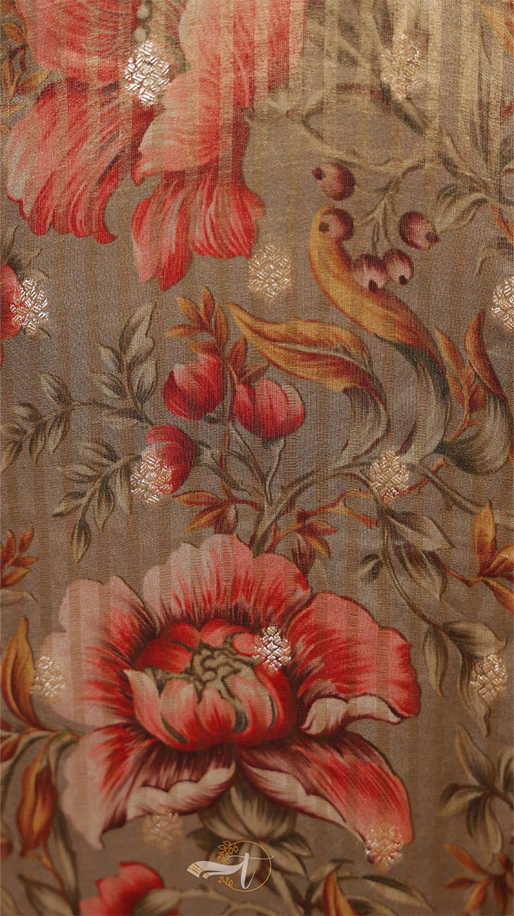 Close-up of a floral patterned fabric with red flowers and green leaves.