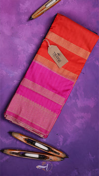 Red and pink saree with a tag on a purple background