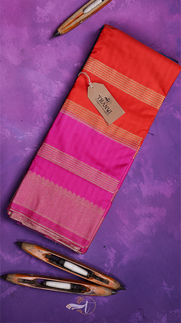 Red and pink saree with a tag on a purple background
