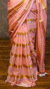 Pink saree with gold stripes on a wooden floor