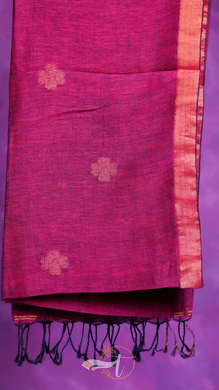 Pink saree with gold floral patterns on a purple background