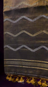 Textile with zigzag pattern and gold accents on a dark background