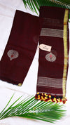 Brown saree with gold and red border on a white background