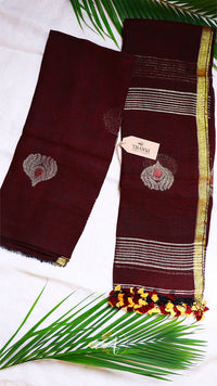 Brown saree with gold and red border on a white background