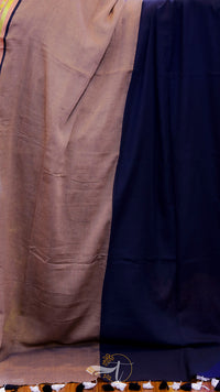 Two pieces of fabric, one brown and one navy, draped over a surface.