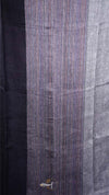 Close-up of a fabric with a striped pattern, transitioning from dark to light blue.