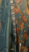 Close-up of a floral-patterned fabric with embroidered details