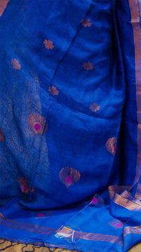Blue fabric with floral patterns on a wooden surface