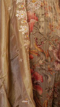 Close-up of a luxurious fabric with floral patterns and embroidery.