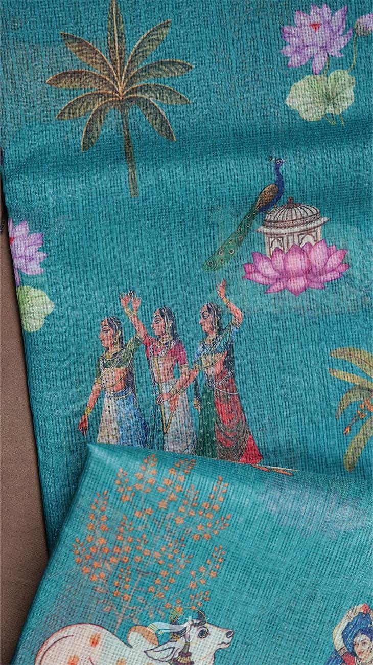 Textile with traditional design of women, peacock, and lotus on a blue background