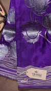 Purple fabric with silver floral patterns and a Thani brand tag.