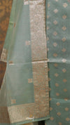 Green fabric with gold patterns and border