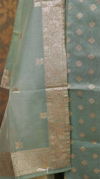 Green fabric with gold patterns and border