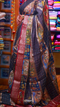 Person wearing a colorful patchwork dress in a fabric store.