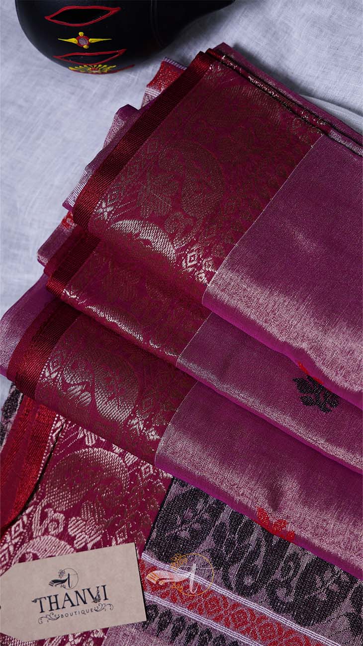 Stack of red fabric with a brand label on a light gray background