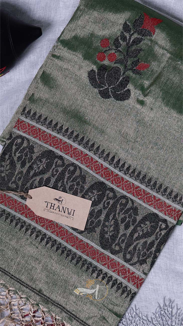 Embroidered fabric with intricate patterns and a Thambi label on a textured surface.