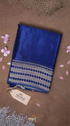 Blue fabric with a pattern on a brown background with flowers