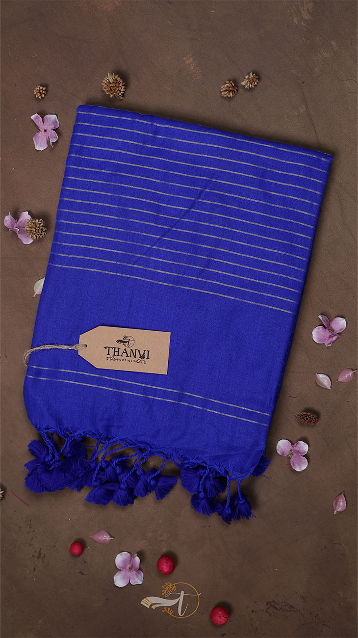 Blue towel with tassels on a brown background with decorative elements