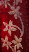 Close-up of floral embroidery on a red fabric background