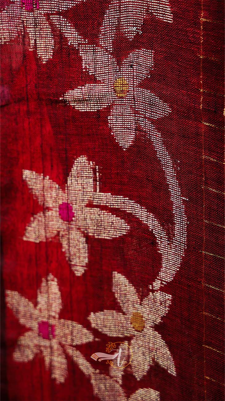 Close-up of floral embroidery on a red fabric background