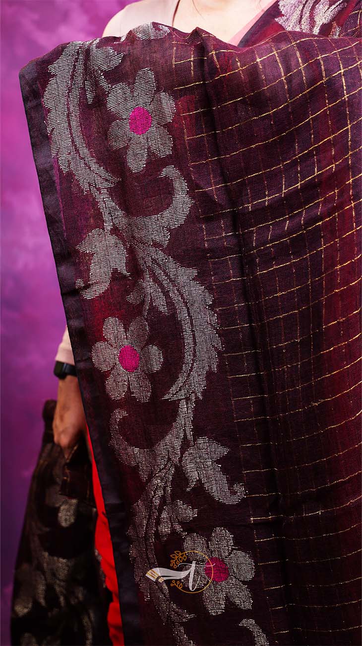 Close-up of a dark purple fabric with floral embroidery on a vibrant purple background