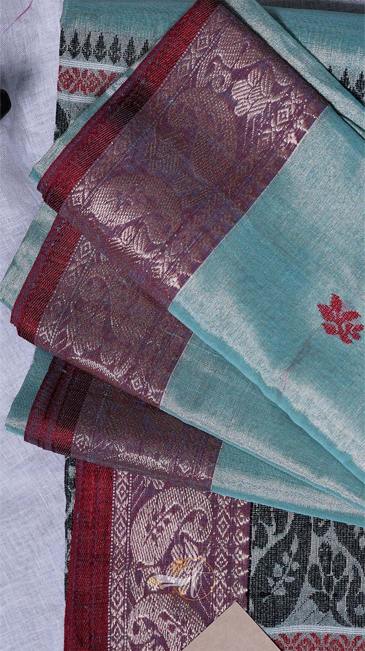 Stack of patterned cloths with maroon and turquoise colors on a light background