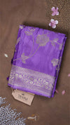 Purple fabric with floral patterns on a brown background