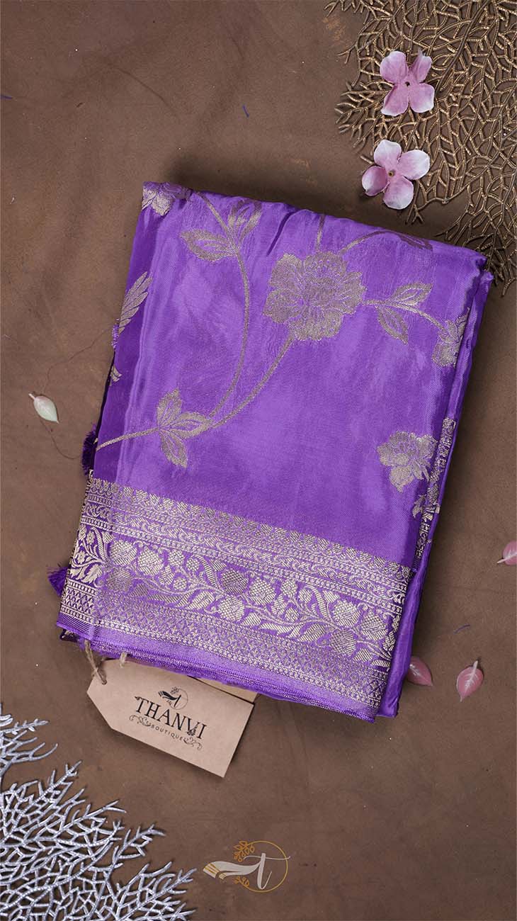 Purple fabric with floral patterns on a brown background