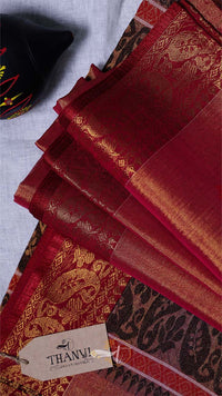 Red and black patterned fabric with a visible brand tag on a light gray background