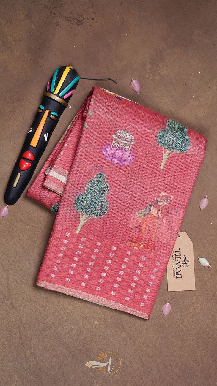 Red fabric with tree patterns and a colorful object on a brown surface