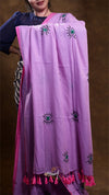 Purple scarf with eye designs and pink border on a brown background