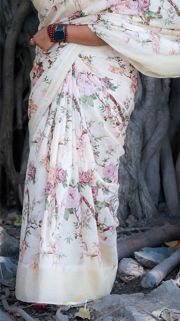 Person wearing a floral saree with a rustic background