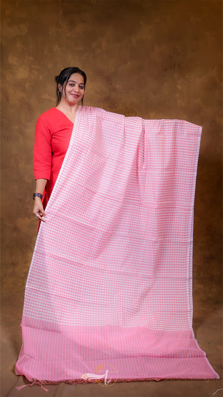 Woman holding a pink saree with a brown background